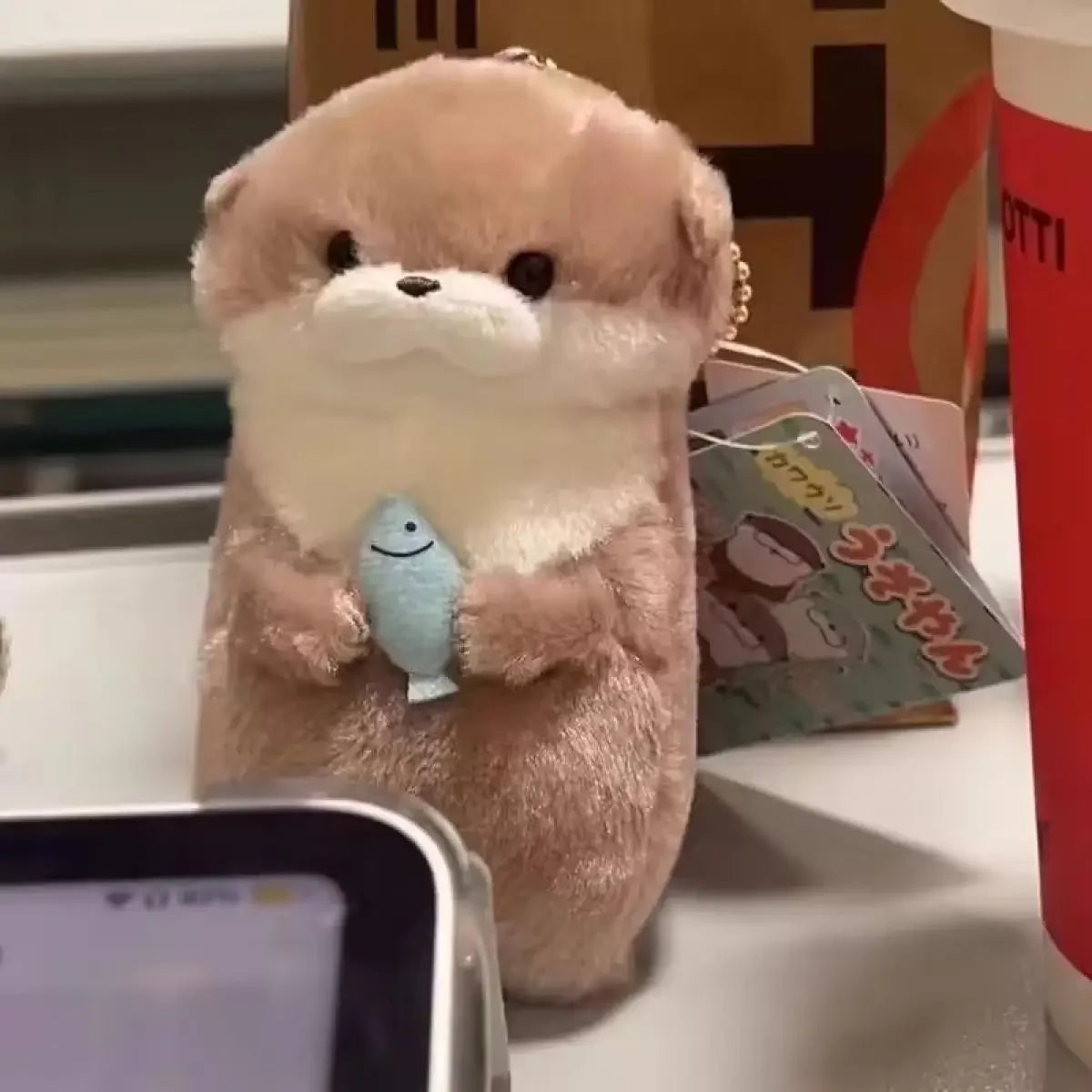 Otter Hugging Fish Plush